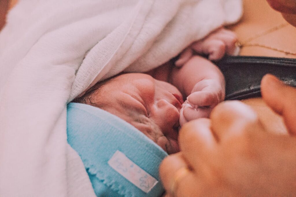Tender Moment of Newborn Cradled Close