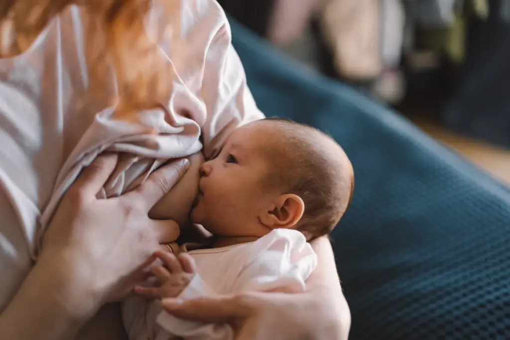 newborn-baby-girl-breastfeeding-lactation-support-mother Newborn baby girl benefiting from lactation support whilst nursing from her mother's breast,.